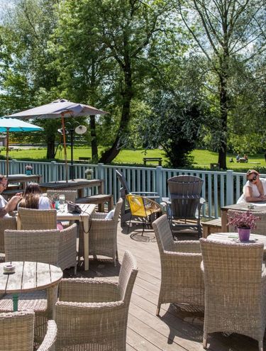 Young's outdoor pub area with view of park and river