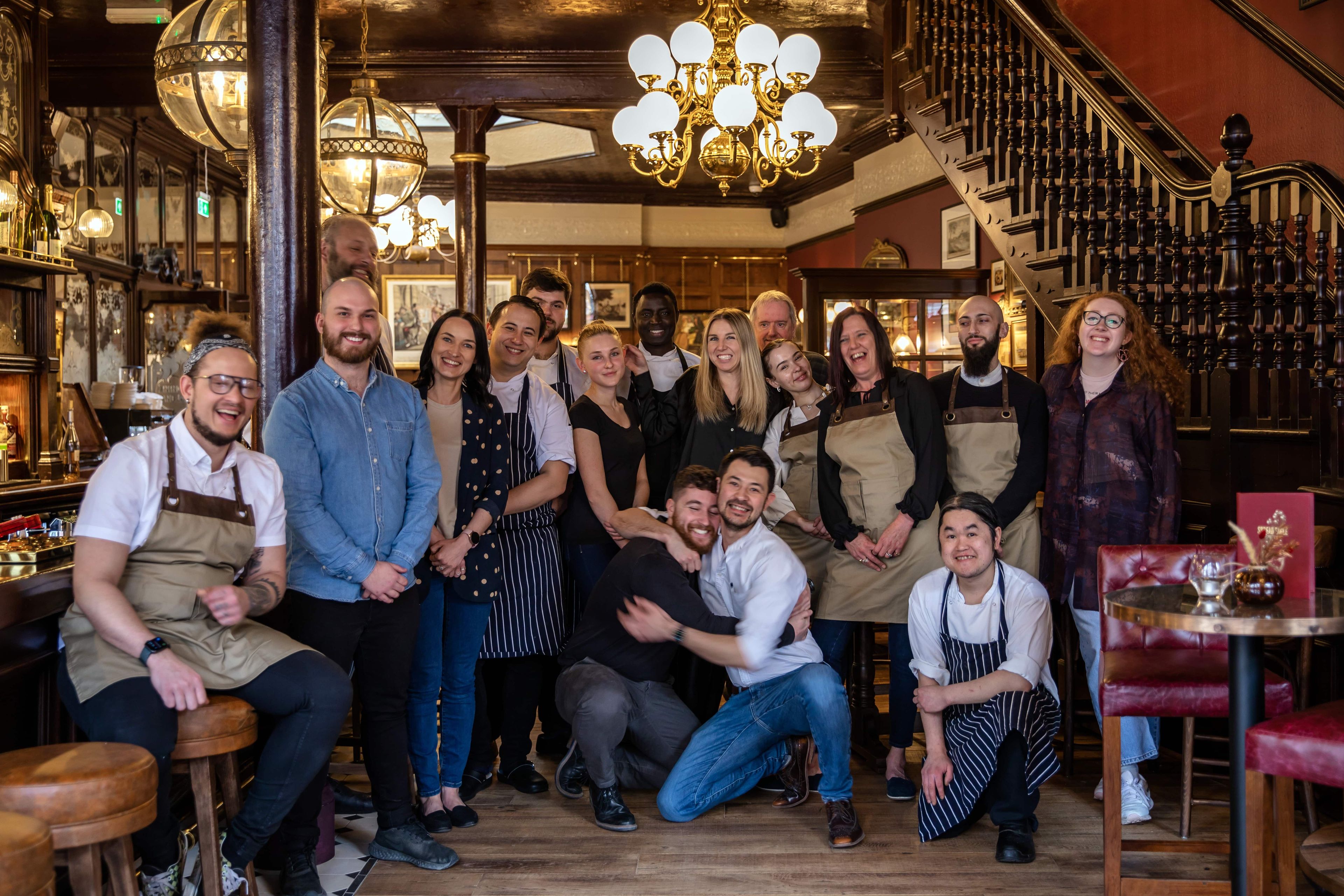 group of Young's staff posing together and hugging in a Young's pub