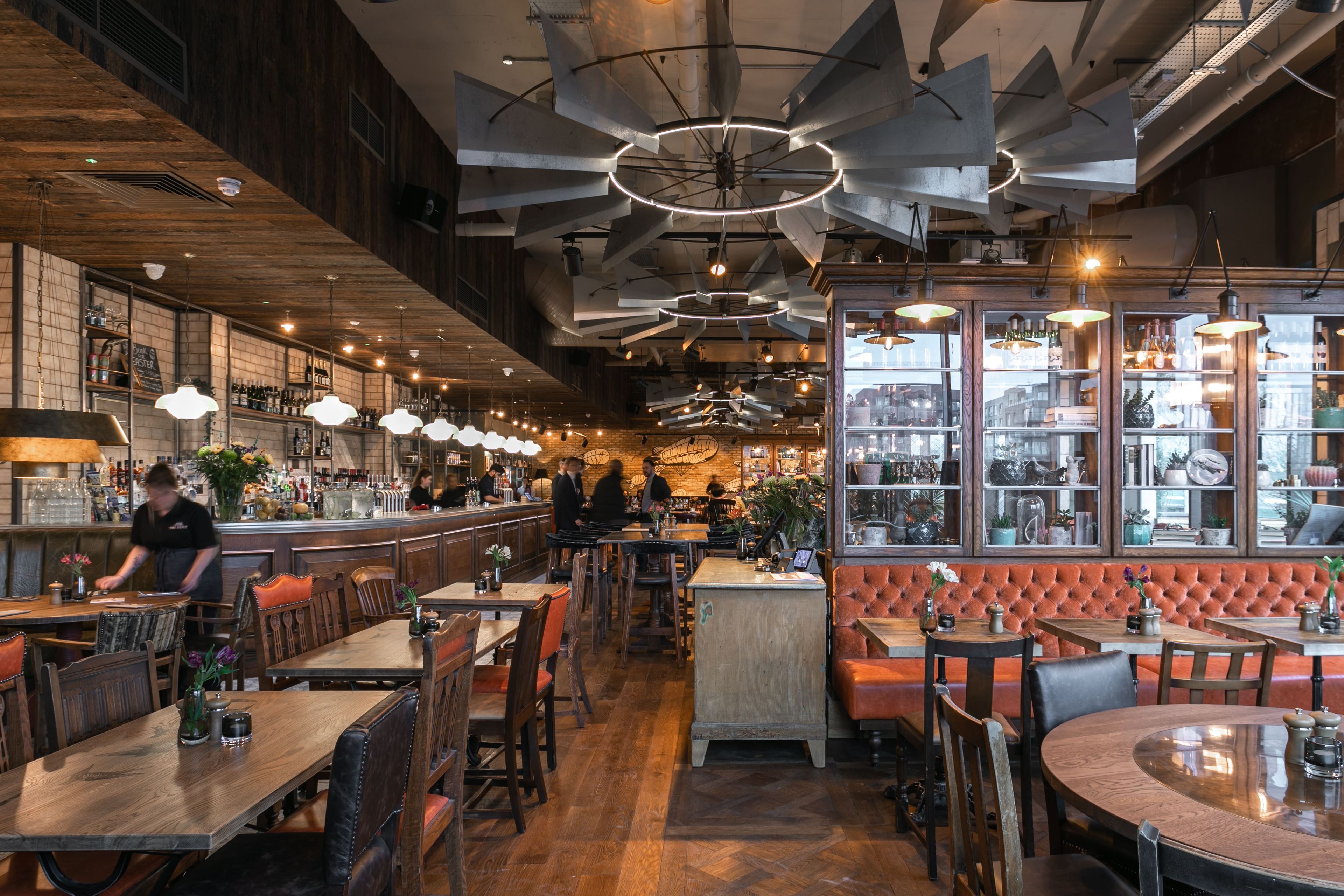 airy Young's pub interior with wooden tables, chairs, and a large bar area