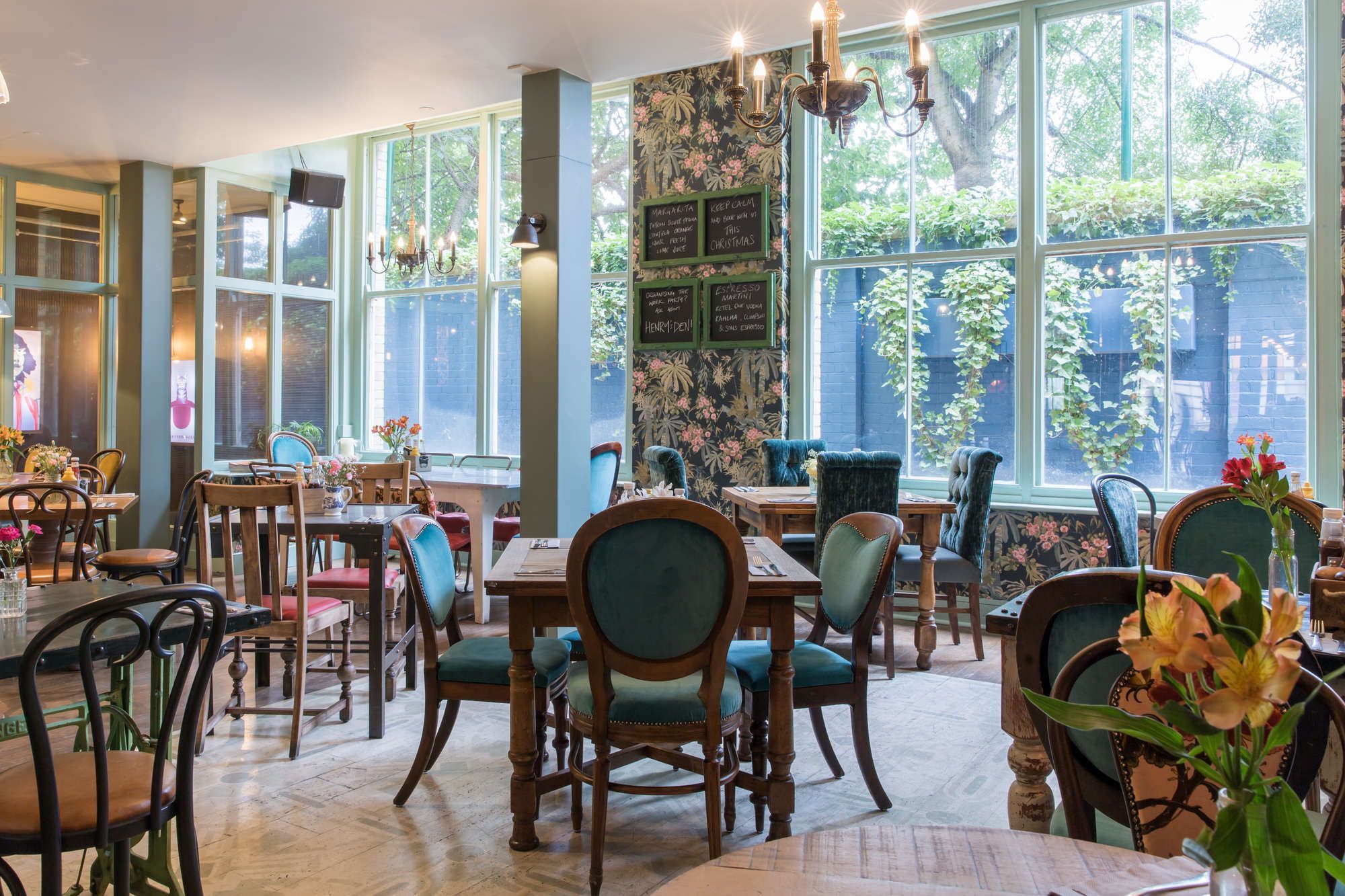 interior view of a Young's pub filled with tables, chairs, and floral accents